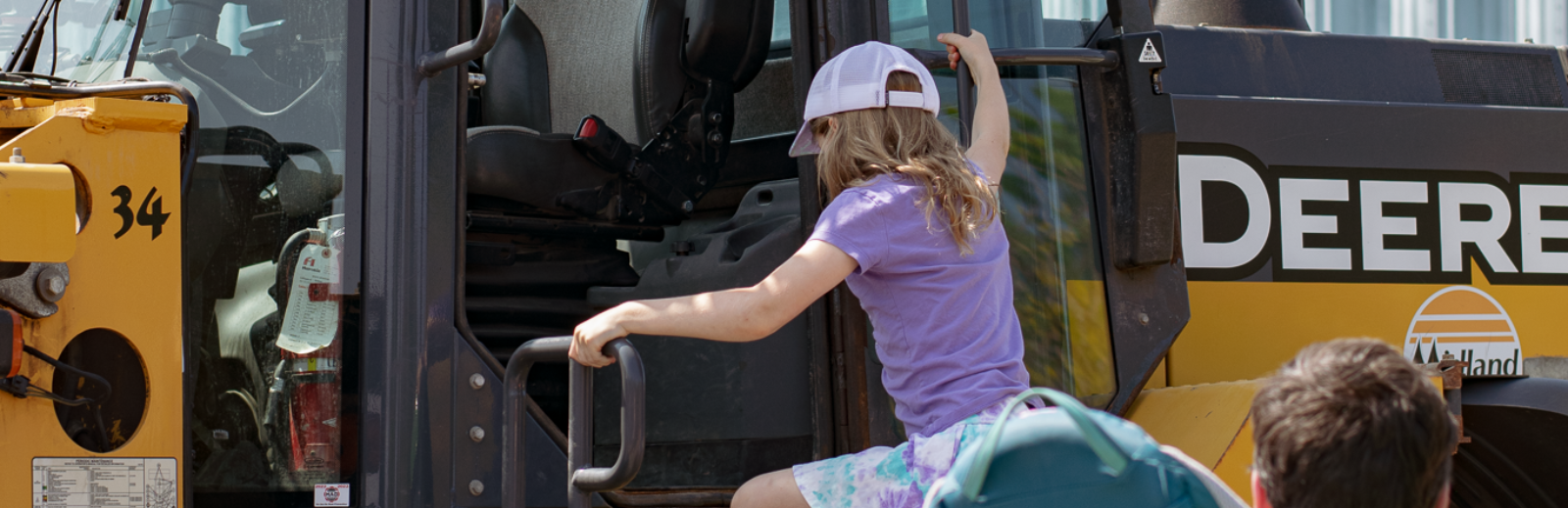 kid sitting in street sweeper