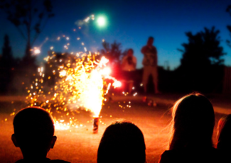people setting off small fireworks