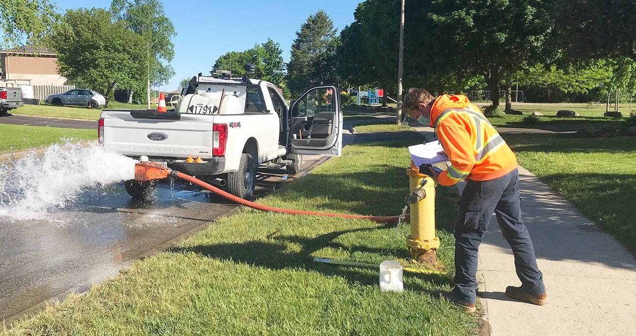 Town of Midland Staff flushing hydrant
