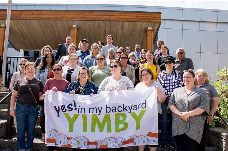 YIMBY Flag Raising People standing with Flag