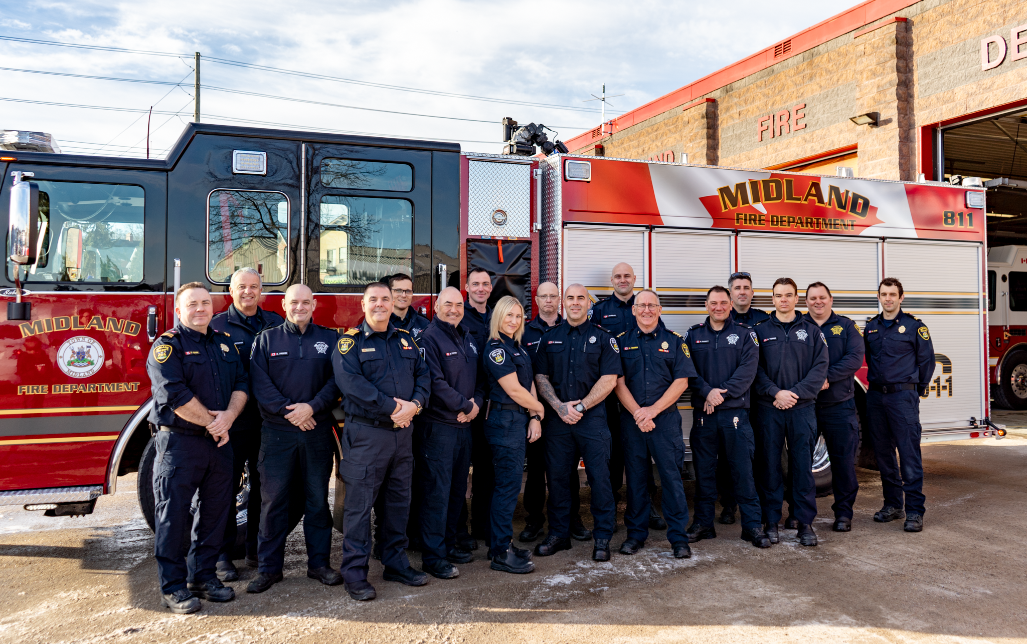 Firefighters standing infront of truck