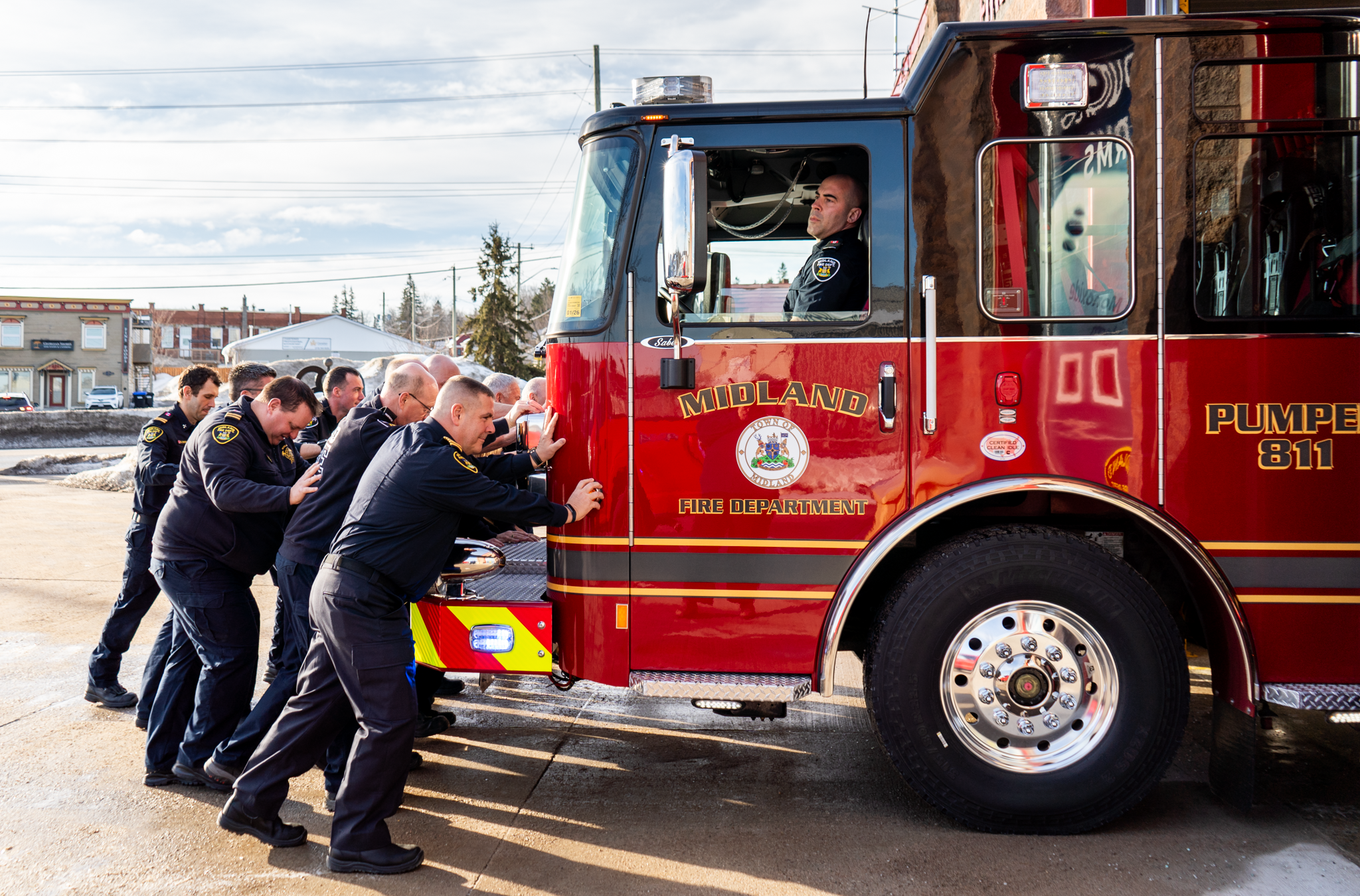 Firefighters pushing truck into engine bay