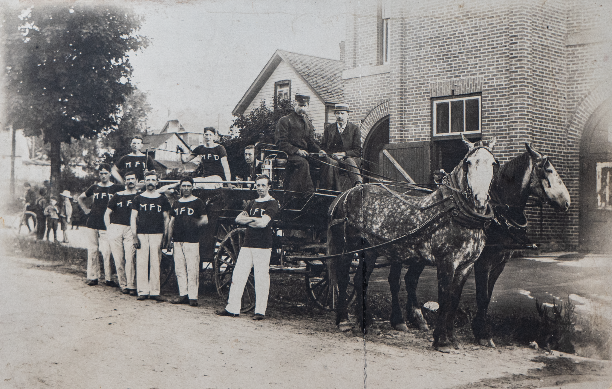 Historical Firefighters standing infront of truck