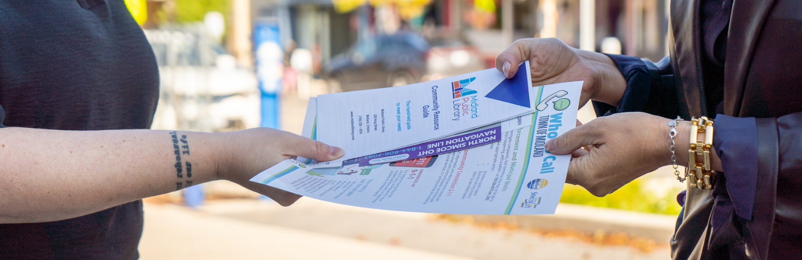 person pointing at wording on sheet