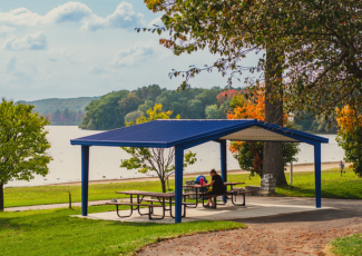 person sitting at a picnic table under pavillion