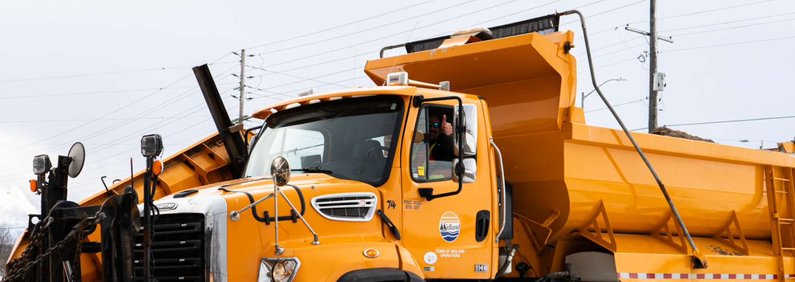 person in truck with thumbs up
