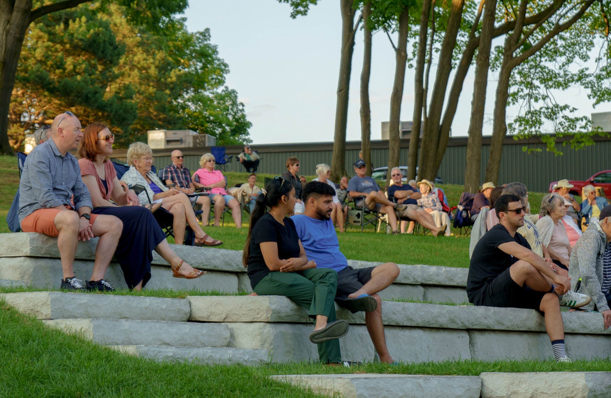 people sitting on rocks facing same way