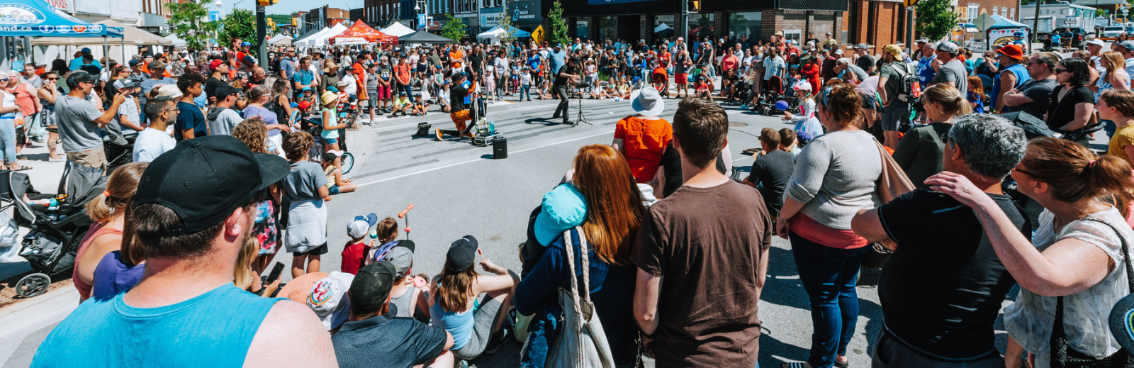 crowd of people watching street performer
