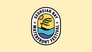 A logo for the Georgian Bay Waterfront Festival featuring a stylized waterfront scene with blue waves, a windswept tree, and a setting sun inside an oval emblem. The text “Georgian Bay Waterfront Festival” surrounds the illustration on a light beige background.